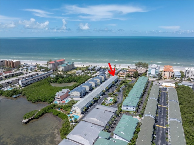 drone / aerial view featuring a water view and a view of the beach