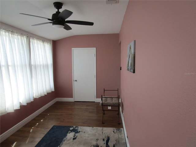 interior space with dark hardwood / wood-style floors, ceiling fan, and lofted ceiling