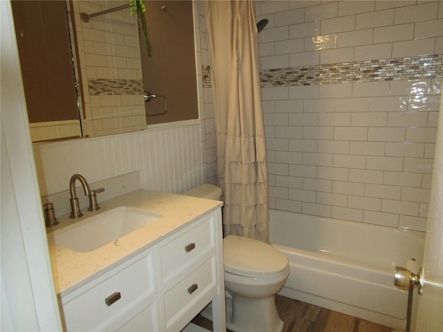 full bathroom featuring hardwood / wood-style floors, vanity, toilet, and shower / bath combo