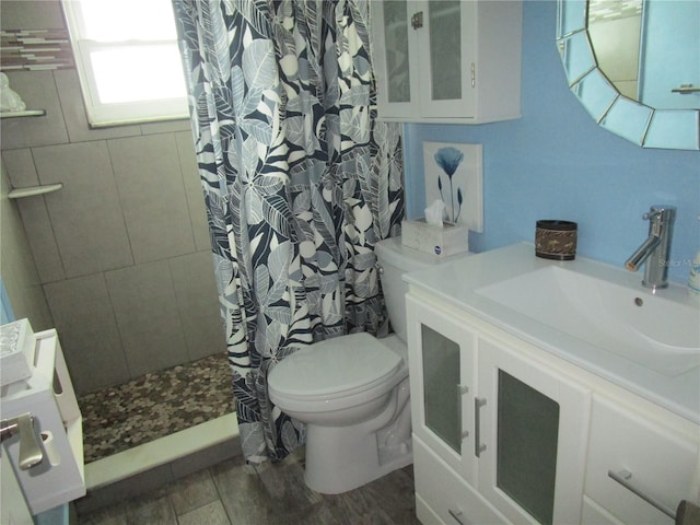 bathroom with curtained shower, hardwood / wood-style floors, vanity, and toilet