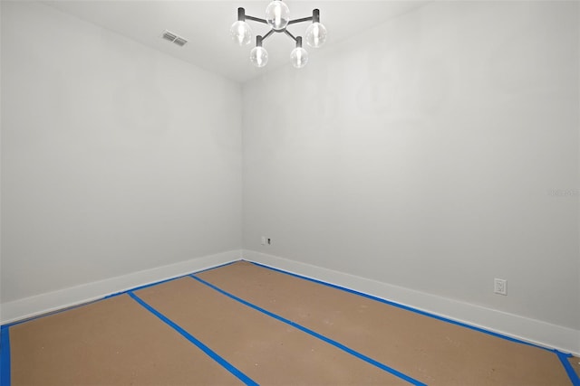 unfurnished room featuring a notable chandelier