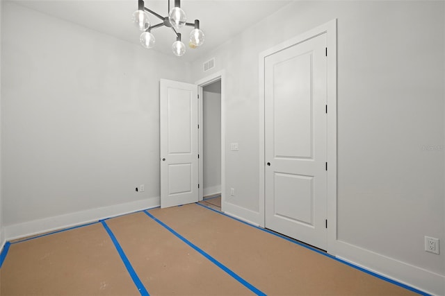 unfurnished bedroom featuring a notable chandelier