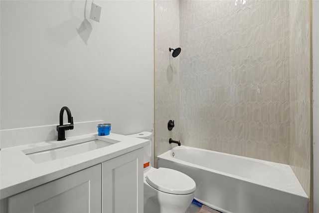 full bathroom with toilet, vanity, and tiled shower / bath