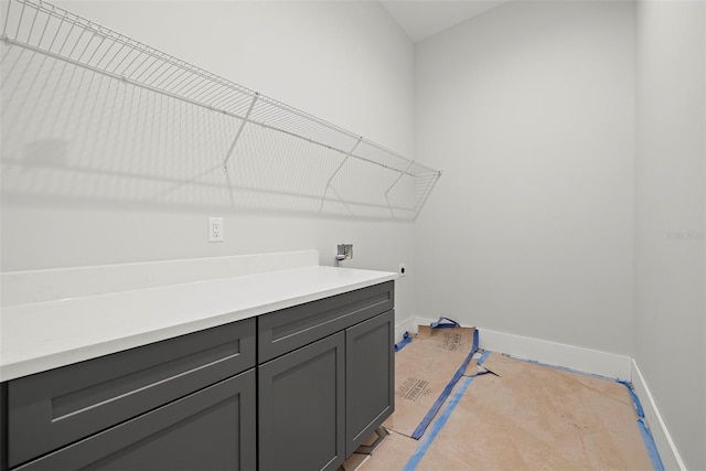 laundry room with hookup for a washing machine, cabinets, light carpet, and hookup for an electric dryer