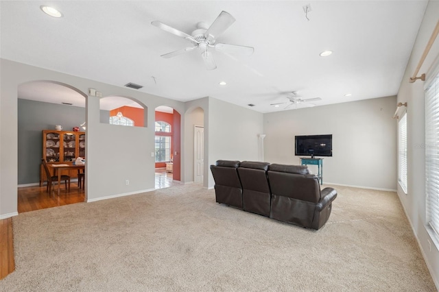 living room featuring ceiling fan and light colored carpet