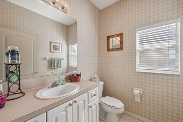 bathroom with tile patterned flooring, vanity, and toilet