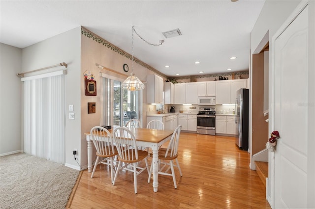 dining space featuring light wood-type flooring