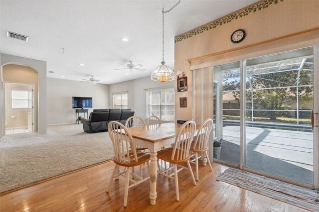 dining area with ceiling fan, plenty of natural light, and hardwood / wood-style floors