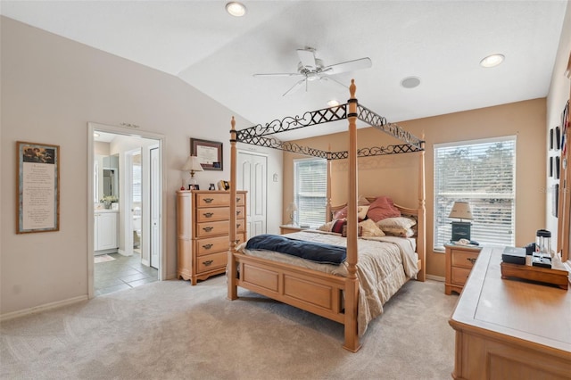 carpeted bedroom featuring connected bathroom, ceiling fan, a closet, and lofted ceiling