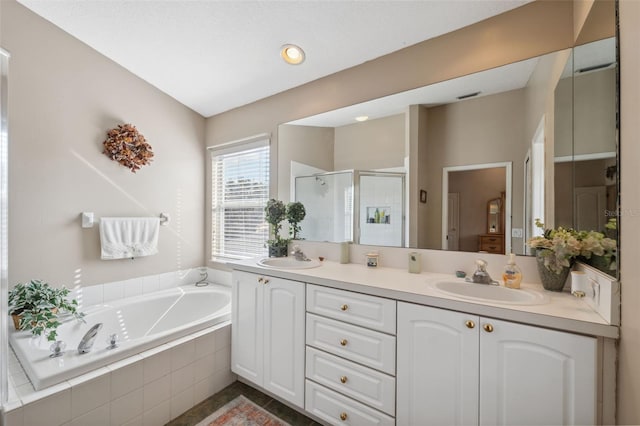 bathroom with shower with separate bathtub and vanity