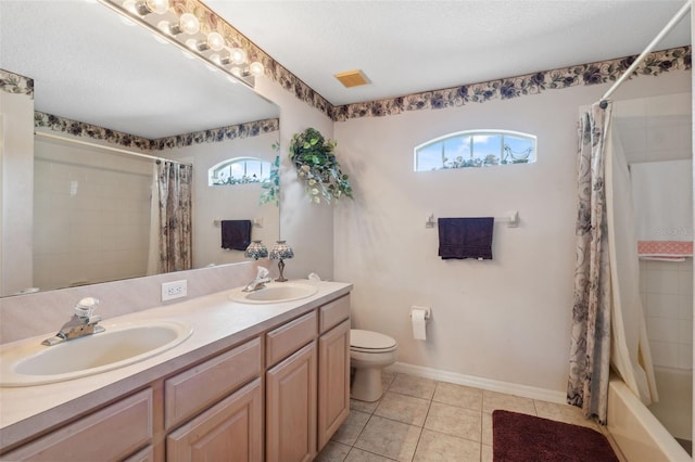 full bathroom featuring shower / bath combo, tile patterned floors, vanity, toilet, and a textured ceiling