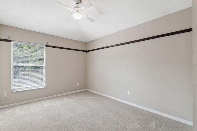 spare room featuring light carpet and ceiling fan