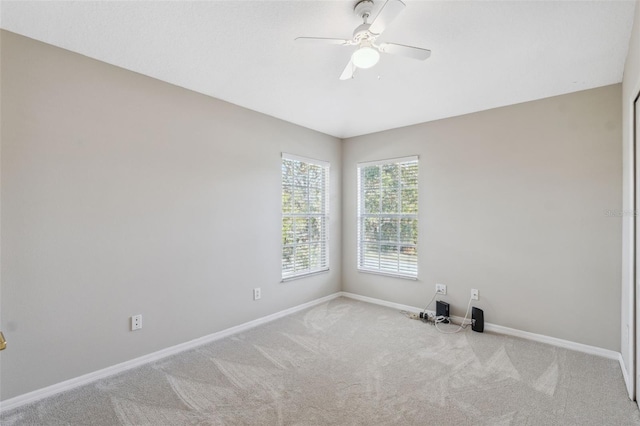 unfurnished room featuring ceiling fan and carpet flooring