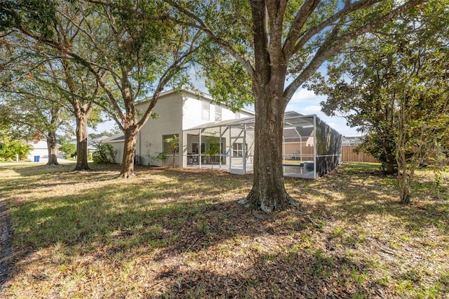 view of yard featuring glass enclosure