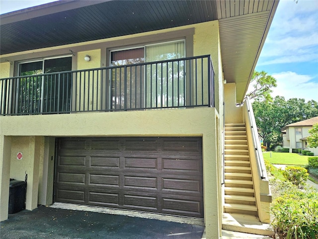 exterior space featuring a garage and a balcony