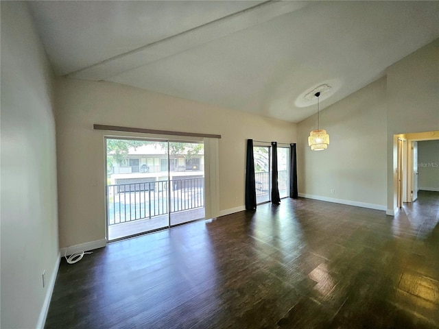 unfurnished room with dark wood-type flooring and lofted ceiling