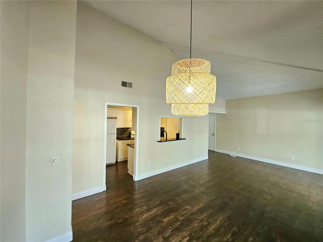 interior space featuring high vaulted ceiling and dark wood-type flooring