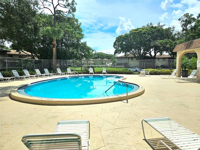 view of swimming pool with a patio