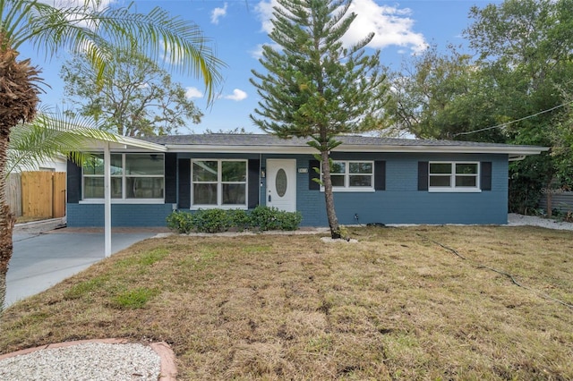 single story home with brick siding, fence, and a front yard