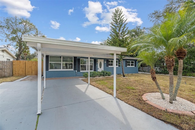 single story home with a front lawn and a carport