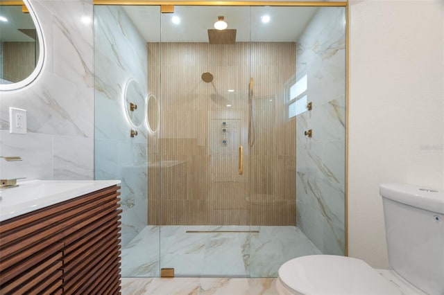 bathroom with an enclosed shower, vanity, tile walls, and toilet