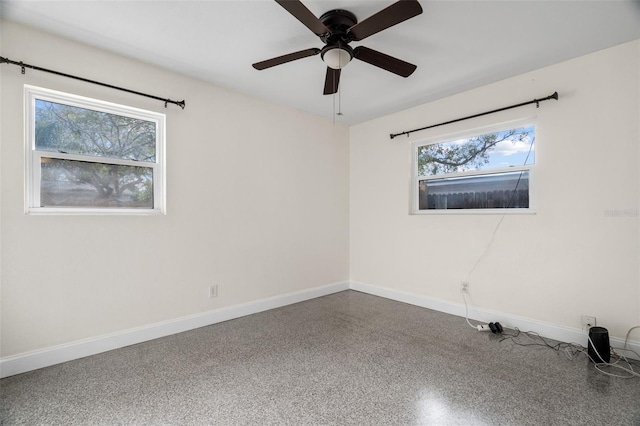 unfurnished room featuring a wealth of natural light and ceiling fan