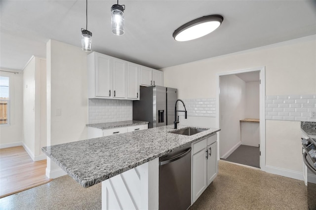 kitchen featuring stainless steel appliances, white cabinetry, sink, and pendant lighting