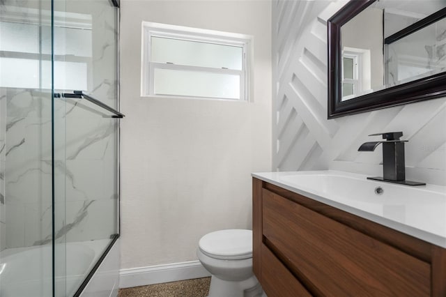 full bathroom featuring vanity, enclosed tub / shower combo, and toilet