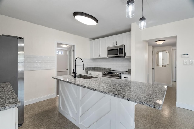 kitchen featuring stone countertops, sink, white cabinets, hanging light fixtures, and stainless steel appliances