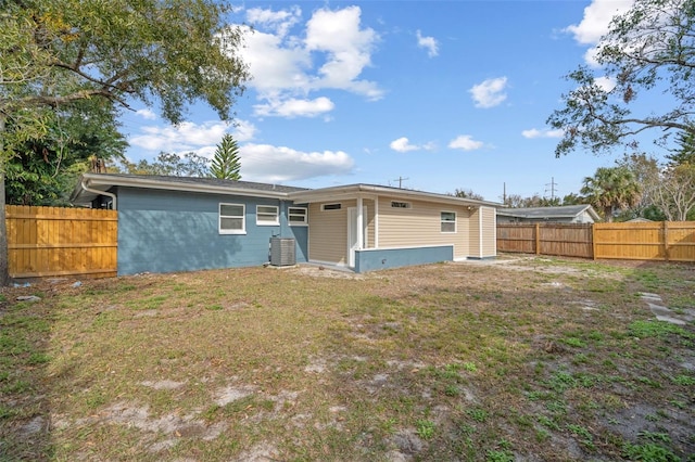 rear view of house with a yard