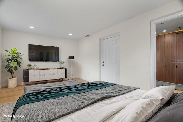 bedroom featuring recessed lighting, visible vents, baseboards, and wood finished floors