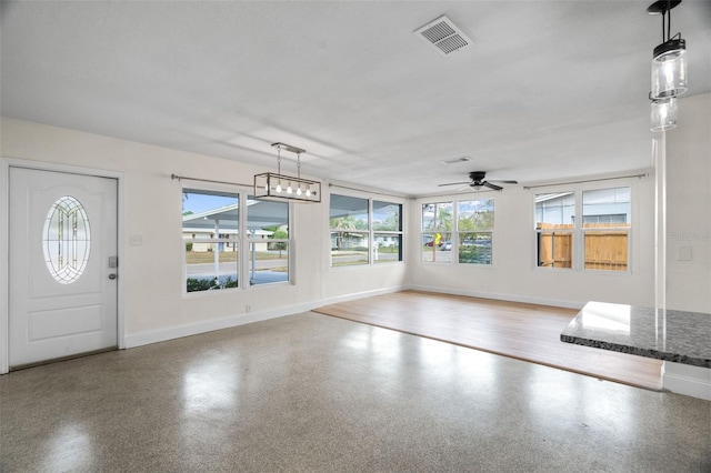 foyer entrance with baseboards, visible vents, ceiling fan, and speckled floor