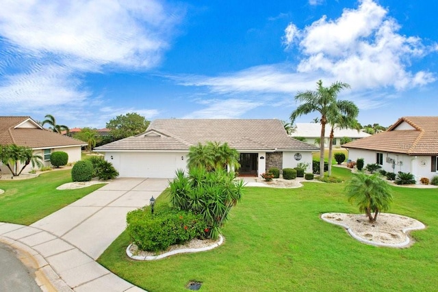 ranch-style house featuring a garage and a front lawn