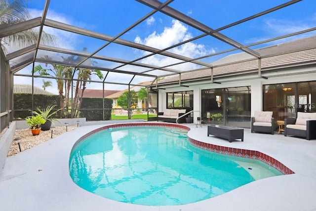 view of swimming pool with outdoor lounge area, glass enclosure, and a patio