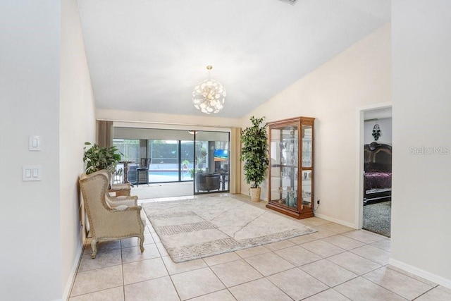 tiled entryway with high vaulted ceiling and a chandelier