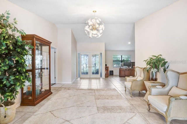 tiled foyer featuring french doors, lofted ceiling, and a notable chandelier