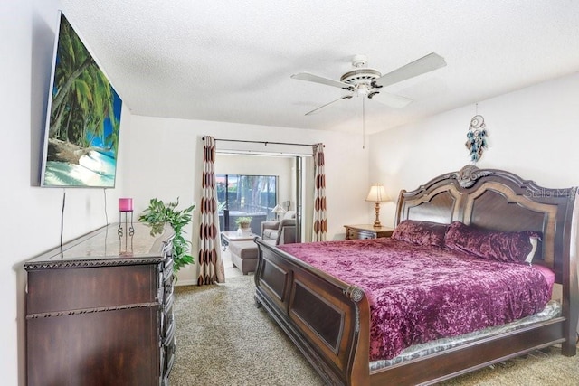 carpeted bedroom with ceiling fan and a textured ceiling