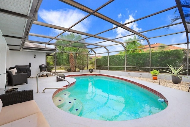 view of pool featuring glass enclosure and a patio area