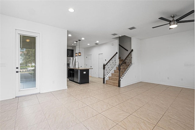 unfurnished living room with ceiling fan with notable chandelier and sink