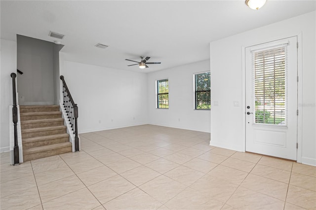 tiled foyer with ceiling fan