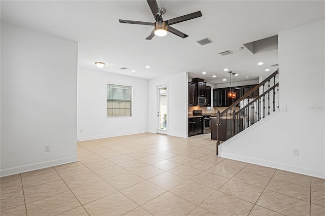 unfurnished living room featuring ceiling fan and light tile patterned floors