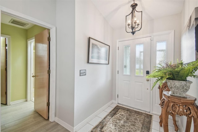 entryway with a chandelier and light wood-type flooring