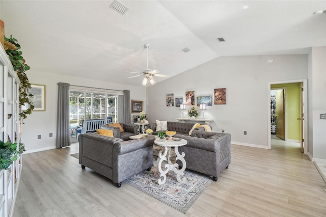 living room with ceiling fan, lofted ceiling, and light wood-type flooring