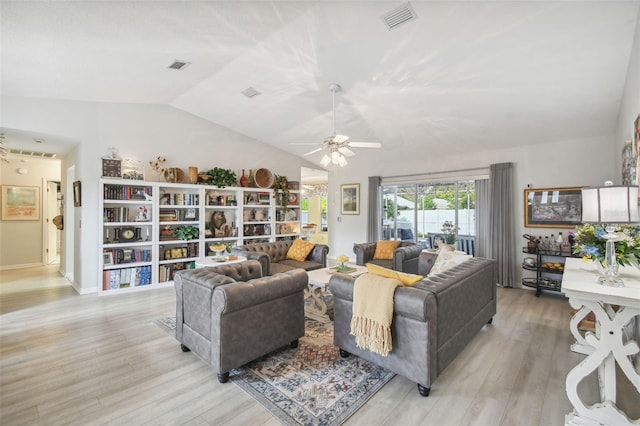 living room featuring ceiling fan, light wood-type flooring, and vaulted ceiling