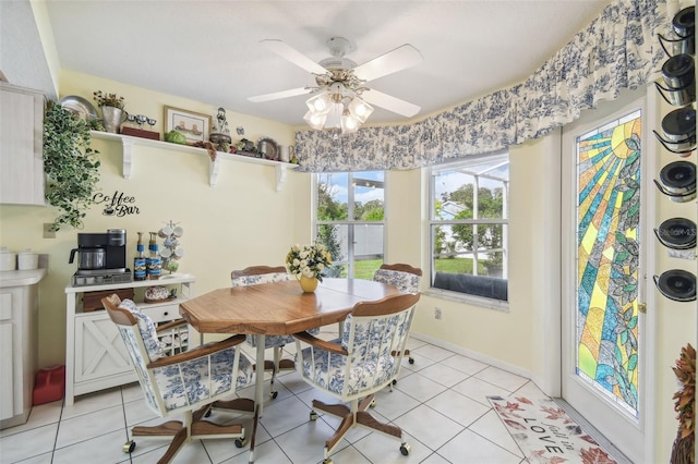 tiled dining area featuring ceiling fan