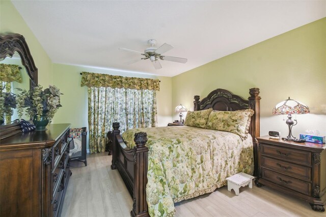 bedroom with light hardwood / wood-style flooring and ceiling fan