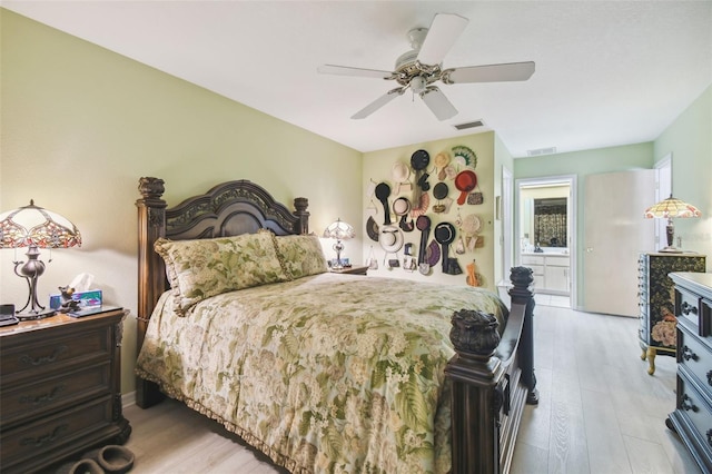 bedroom with ceiling fan, light hardwood / wood-style floors, and connected bathroom