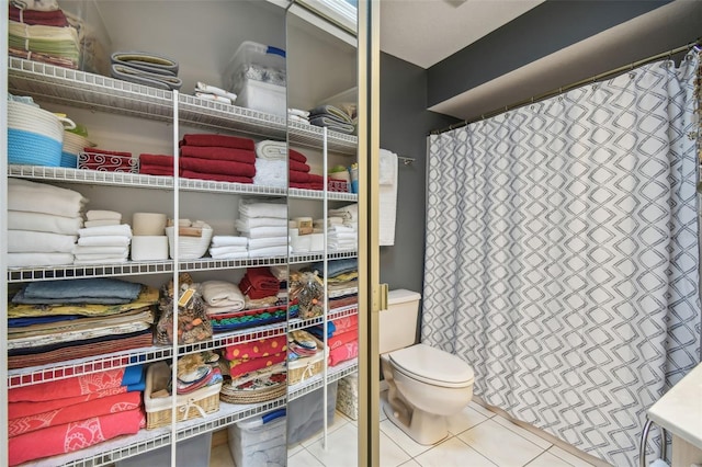 bathroom featuring tile patterned flooring and toilet