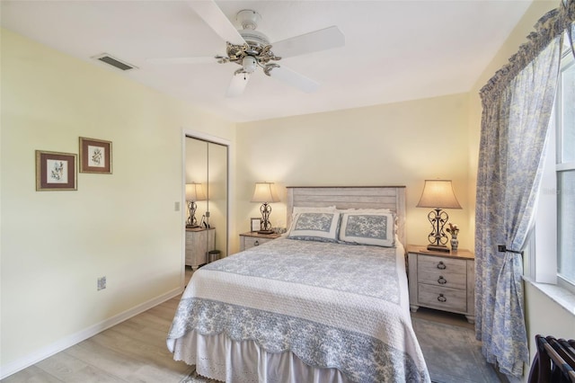 bedroom featuring ceiling fan, a closet, and wood-type flooring