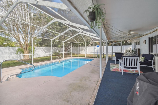 view of pool with an outdoor living space, glass enclosure, and a patio area